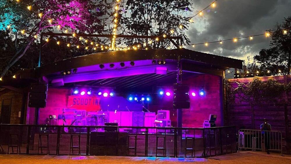 The Historic School Inn stage, lit in purple