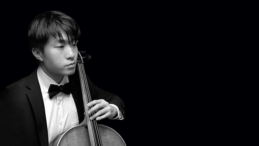A black and white photo of a cello musician