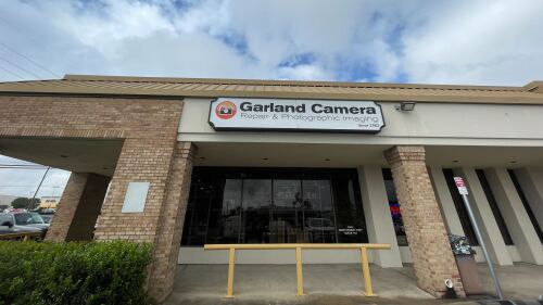 Storefront that reads, "GARLAND CAMERA: Repair and Photography Imaging since 1962"