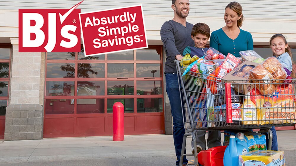 A family with a loaded shopping cart outside BJ's.