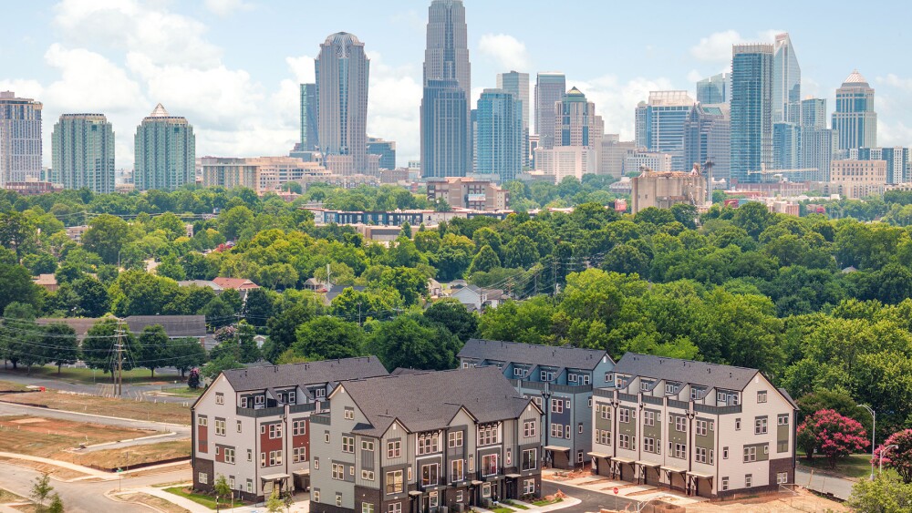A townhome community in the foreground with Charlotte skyline in background