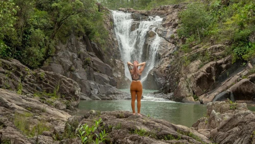 Austin-based gamer and influencer Ava poses near a waterfall.