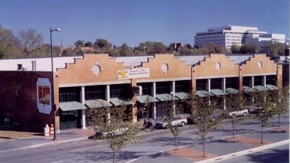 Photo of an old strip of brick buildings.