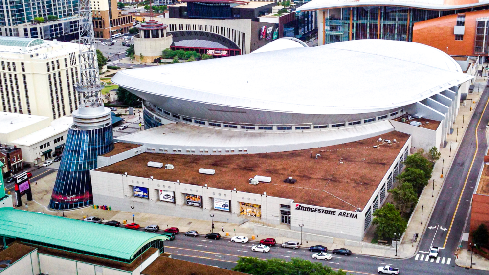 An aerial view of Bridgestone Arena on The Twelve Thirty Club side with a portion of Music City Center in the background.