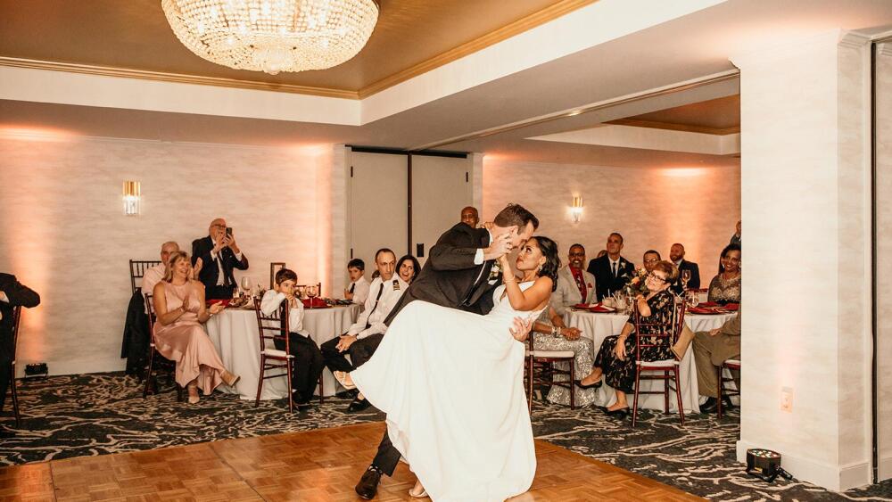 Groom dipping bride during dance on the dance floor