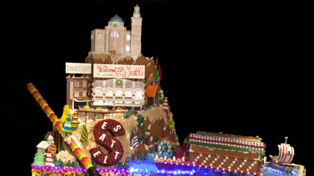 A gingerbread house that shows local Seattle landmarks and an "S" cookie with Seattle written on it
