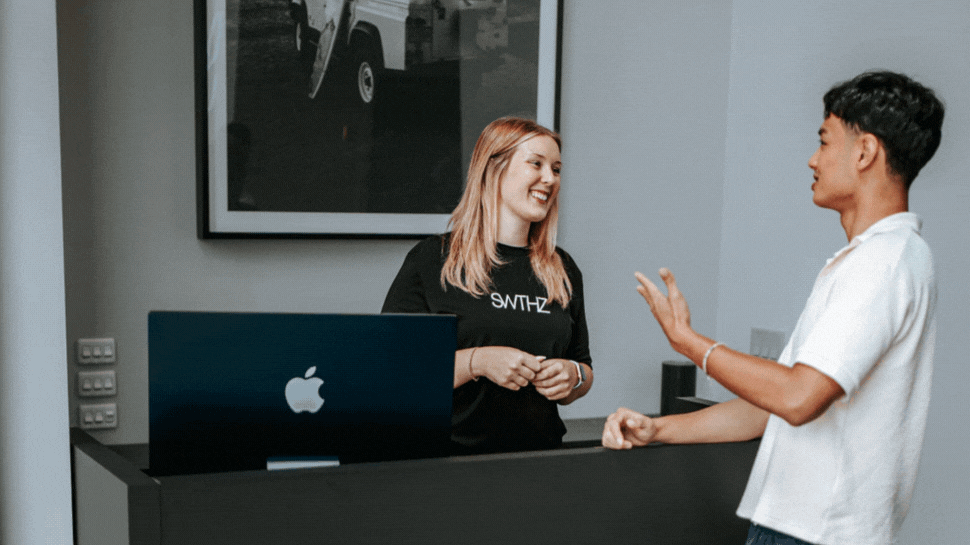 A rotating gif of three photos: One is a man talking to a woman working at the front desk of the studio. Two is a woman stretching in a sauna. Three is a man in a cold plunge tub.