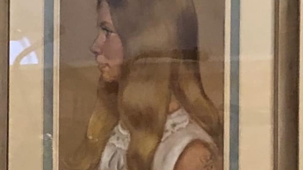 A framed portrait of a young girl in a white dress