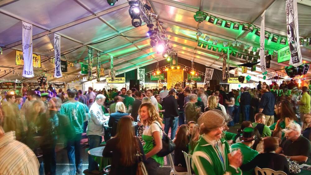 A crowded pavillion of people wearing green for Kells' St. Patrick's Day Festival.