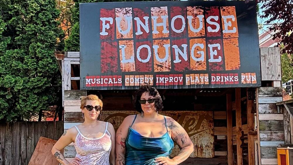 Two people standing in front of the circus-style entrance of Funhouse Lounge in Portland.