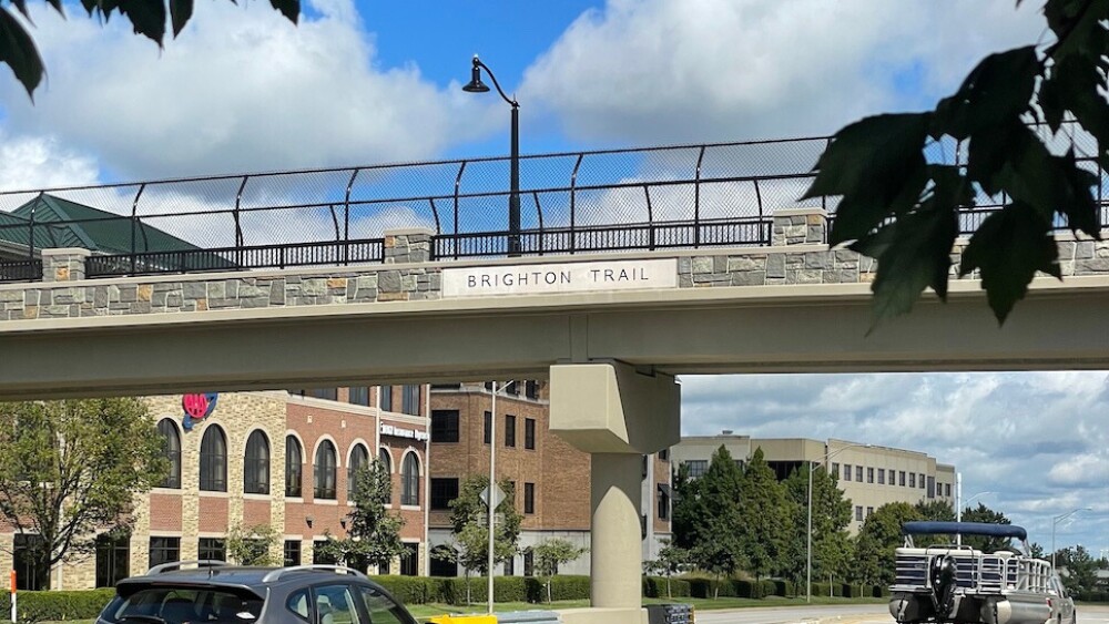 Cars passing under the pedestrian bridge