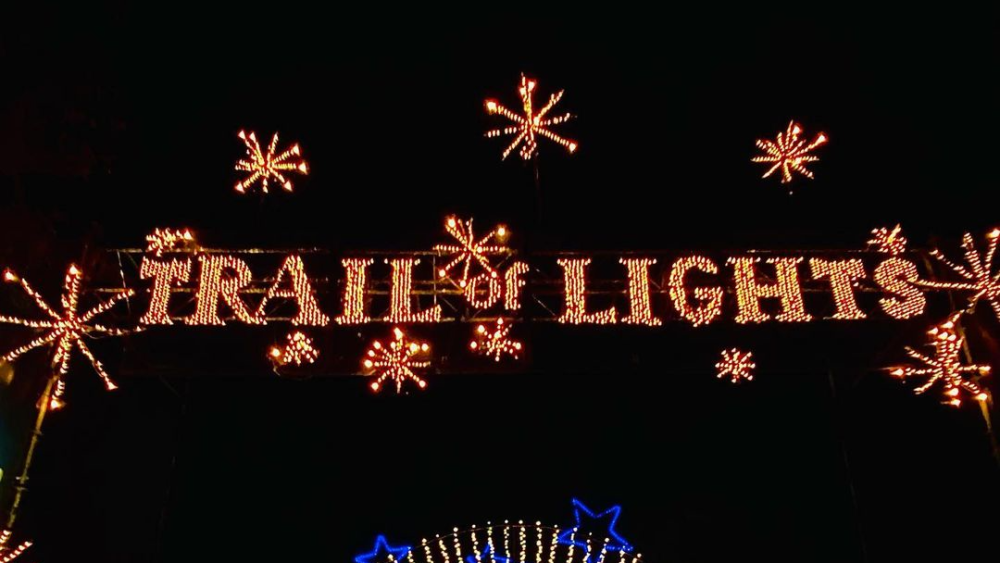 A car driving into the entrance of the Trail of Lights
