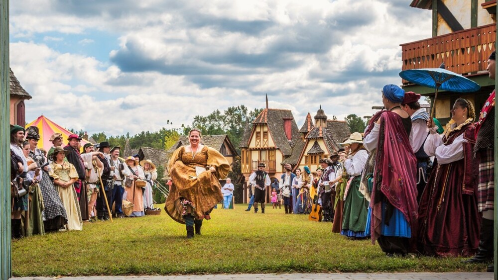 A group of people lined up in renaissance festival attire.