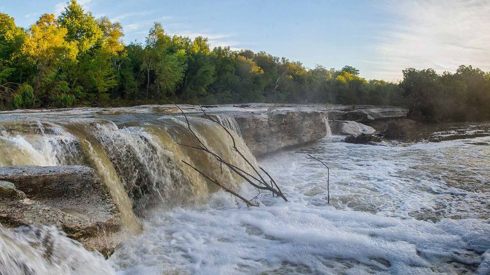 Gorgeous view of the waterfalls at Lower McKinney Falls State Park in Austin, Texas.