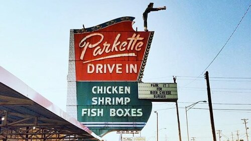 The red and green Parkette Drive In sign that says chicken, shrimp, fish boxes