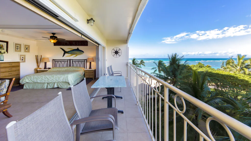 A Vrbo rental listing showing a bedroom with an ocean view.