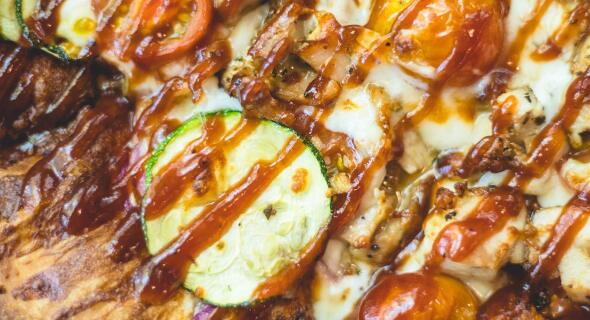 A glazed pizza with garden veggies
