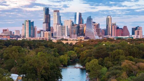 the Austin, Texas skyline with Barton Springs Pool visible in the foreground.
