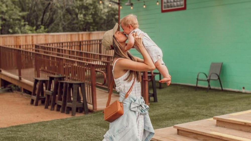 Influencer Olivia and her son playing outside of an Austin-based restaurant.