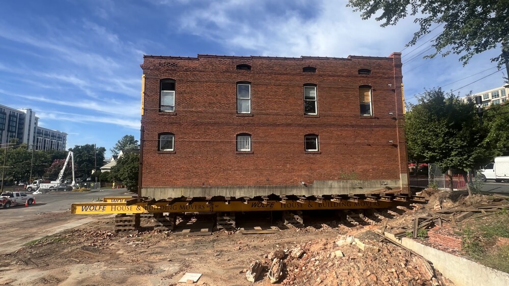 The historic Leeper Wyatt Building stands beneath a blue sky.