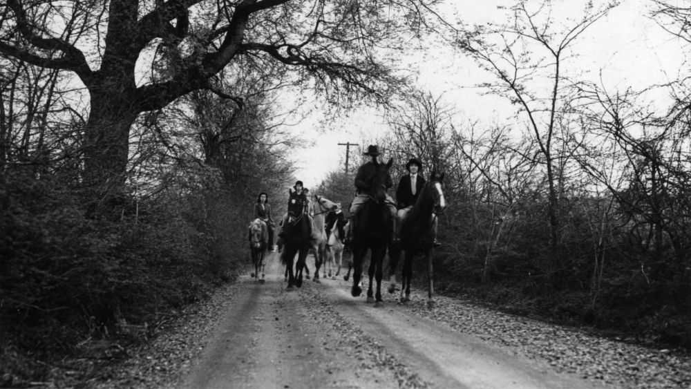 People travel on horses down a once gravel Granny White Pike.