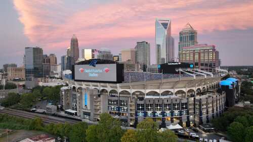 An aerial shot of Uptown Charlotte with Bank of America Stadium in the foreground.