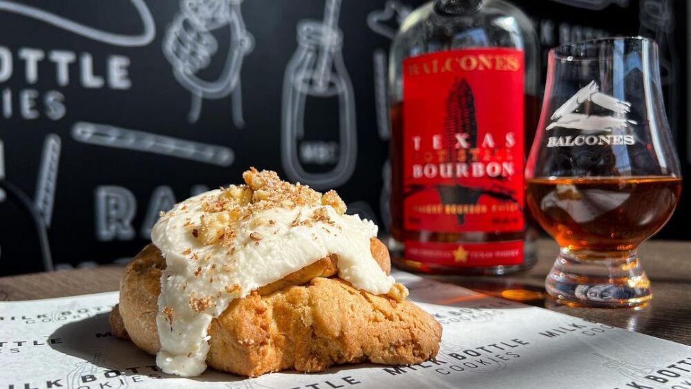 Photo of a cookie next to a whiskey bottle.