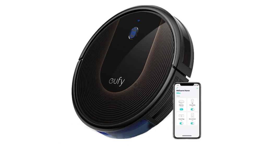 A round robot vacuum and iPhone