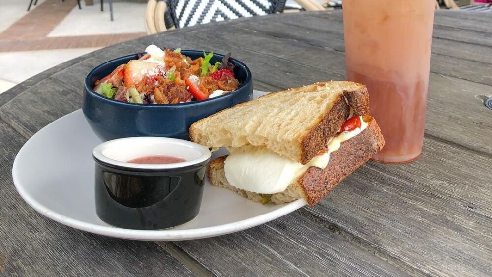 A sandwich, salad, and iced drink from Black and Brew