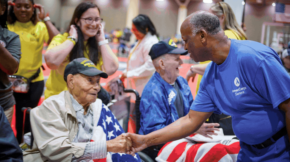 Rotating images of people shaking hands with veterans and volunteering at local schools, in community gardens, and with school murals.