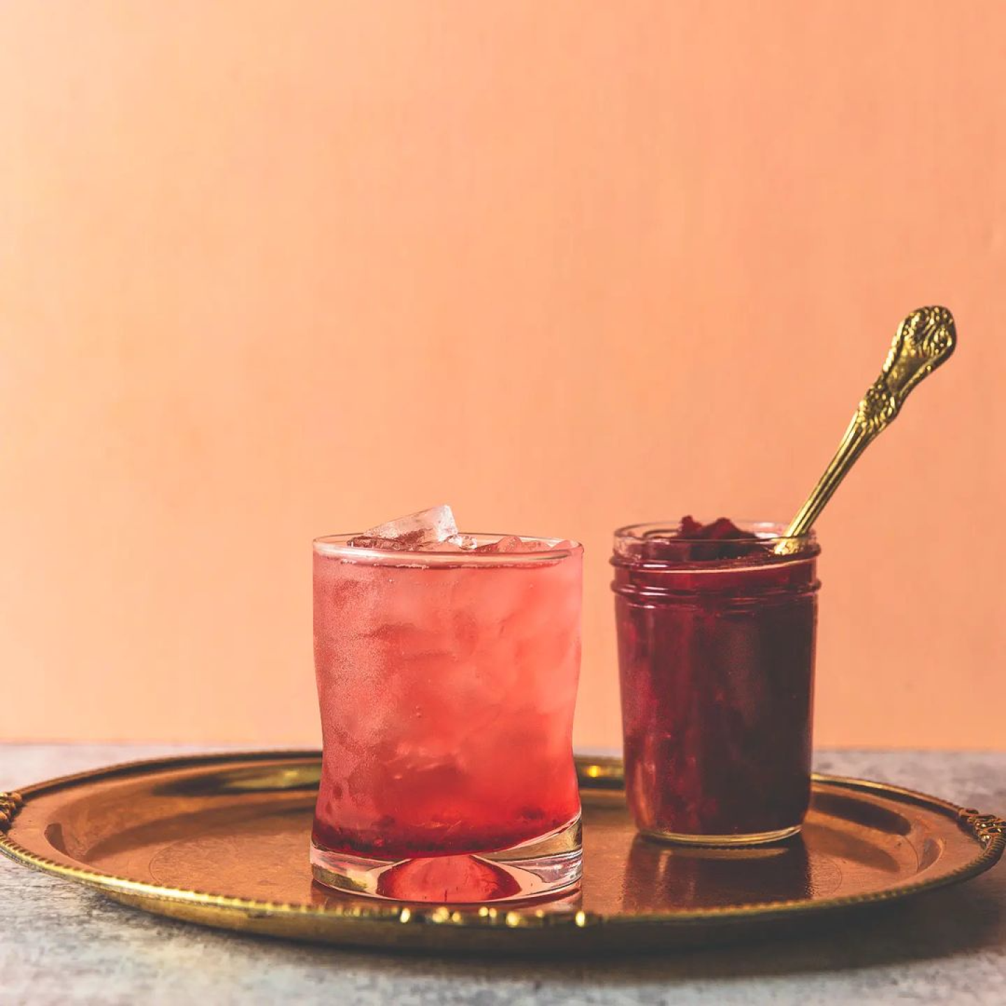 Two cocktails on a silver tray.