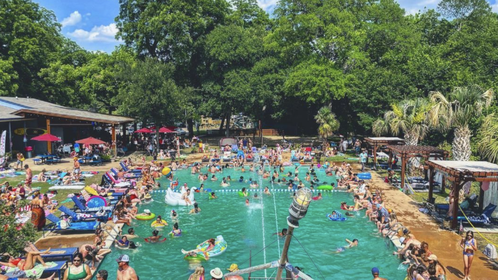 A picture of hundreds of Dallas residents enjoying a day at the pool.