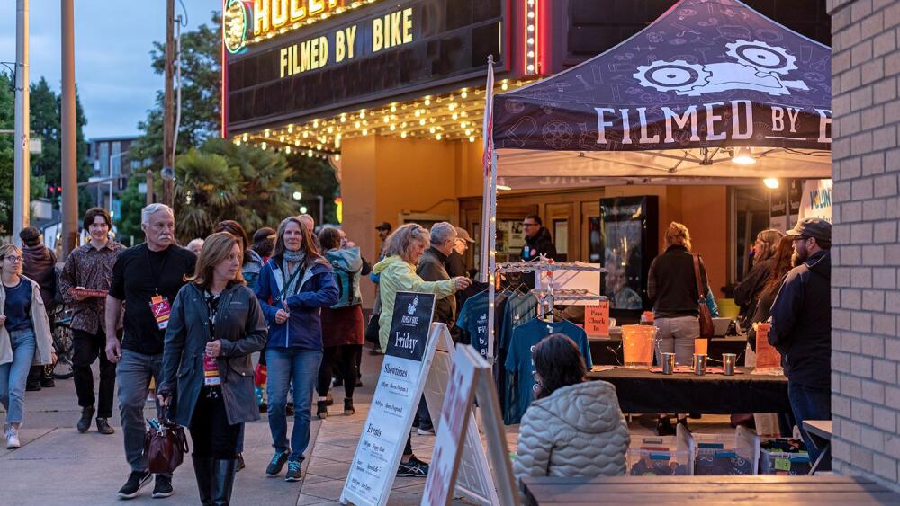People gather outside a theater in Portland for the Filmed by Bike Film Festival