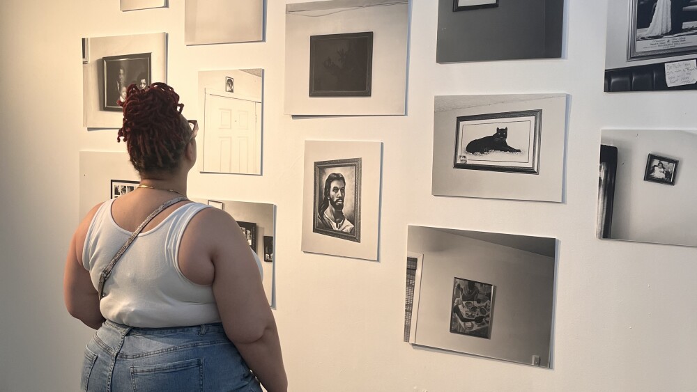 A person viewing art on a wall.