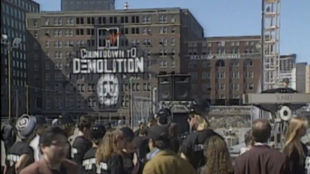 A crowd gathers in front of a large brick building.