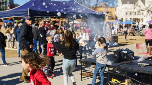 Kids play with a bubble machine at Flannels & Frost in Raleigh, NC.