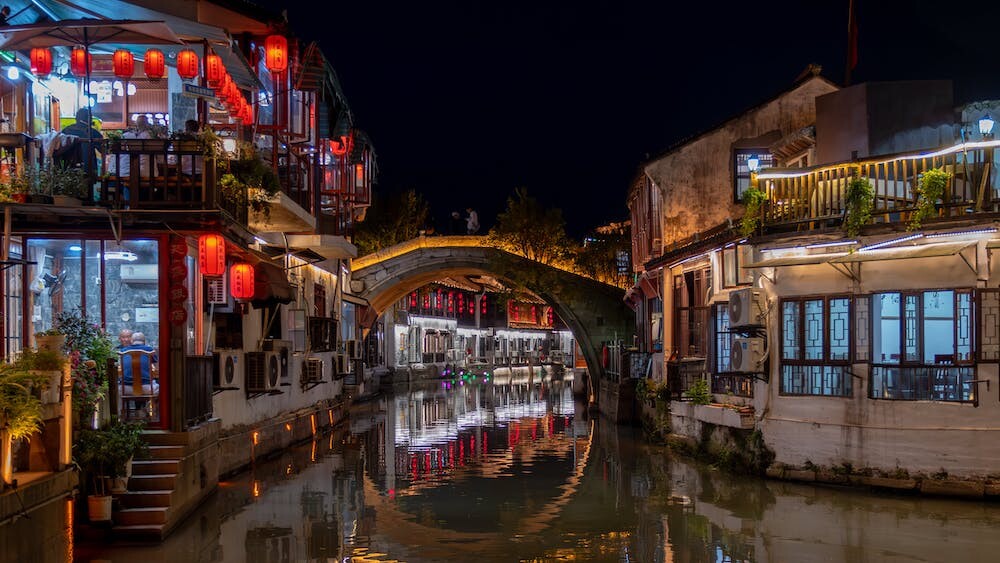 A night scene along the Shantang River in Suzhou shows lanterns and tea houses.