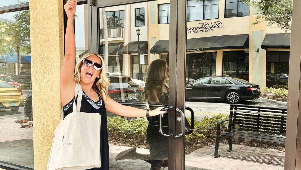 The owner of Amelia Paige Boutique poses outside of her new storefront in Lakeside Village.