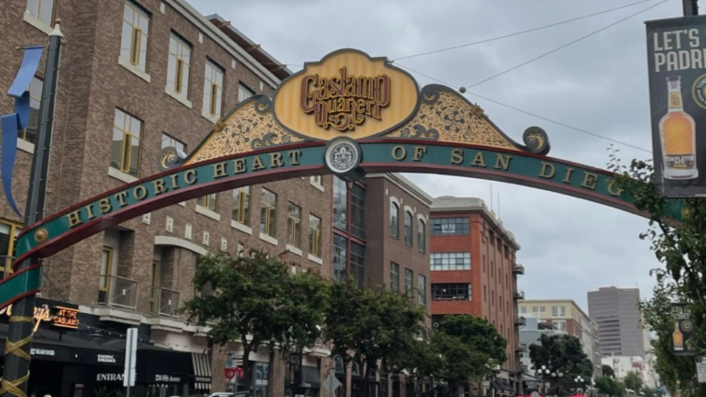 Gaslamp quarter sign with cloudy sky in the background.