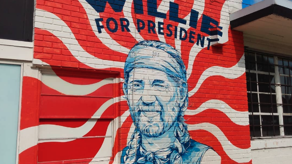 A striped background behind a blue Willie Nelson.
