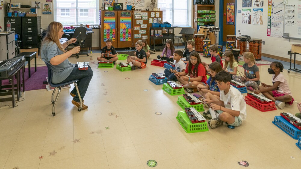 WStoday: teacher instructing students on how to play drums