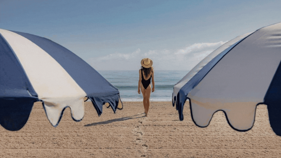 Photo 1: A beachfront scene of a woman between two umbrellas, Photo 2: Overhead shot of umbrellas in a row on a beach, Photo 3: A woman in a pool at a resort