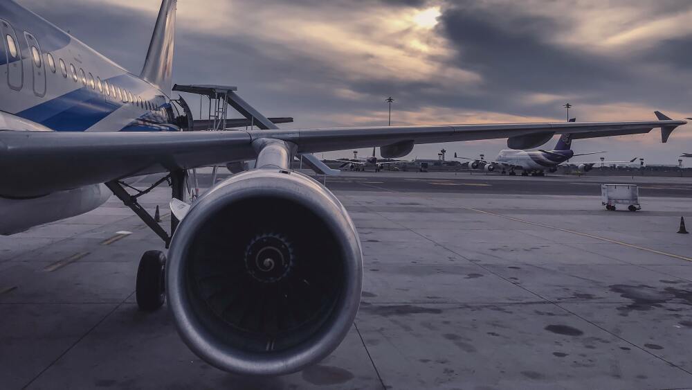 The jet engine of a plane on an airfield.