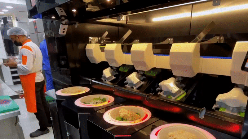GIF of a salad-making robot in action