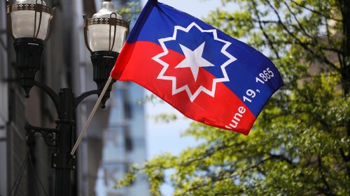 A commemorative Juneteenth flag flying in downtown Lexington.