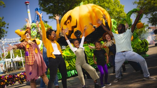 A family poses with trick or treat characters at Carowinds.