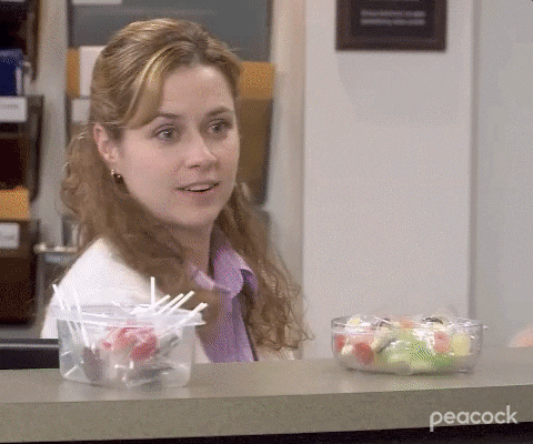 A gif of Pam from the Office holding up bags of candy