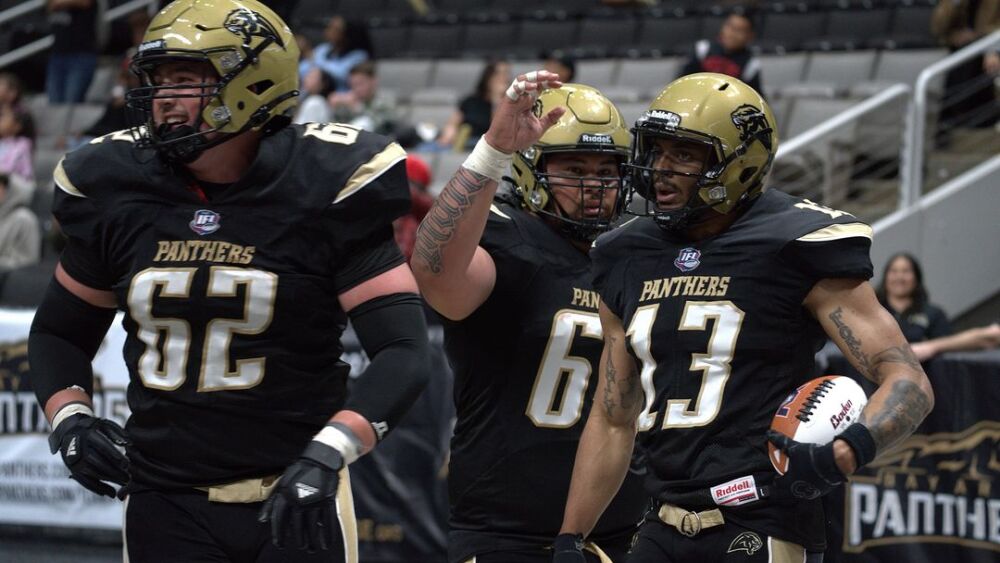 Three Bay Area Panthers players high five each other. 