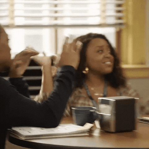 A gif of cast members of Abbott Elementary high-fiving