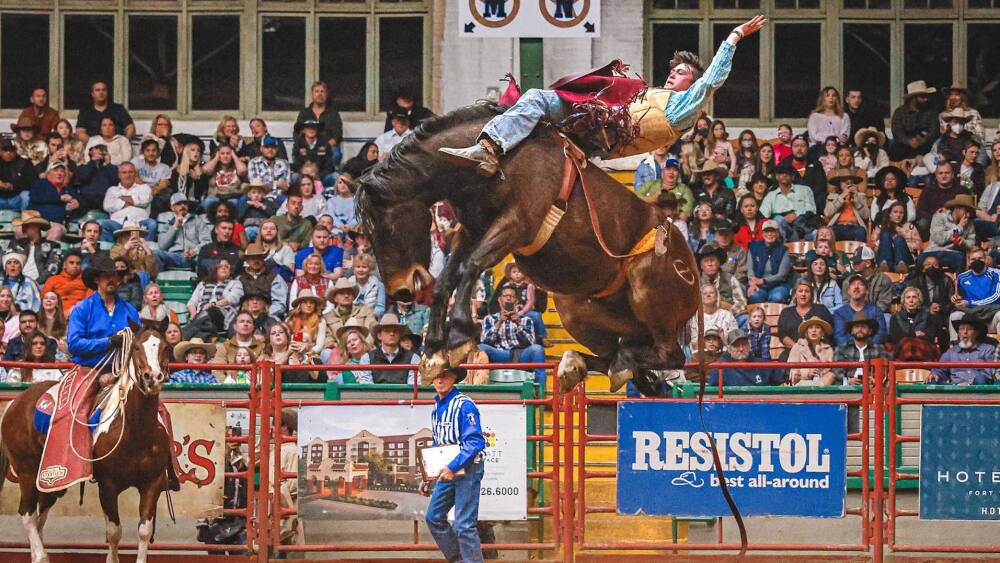 Photo of man bucking on horse.